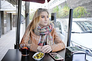 Portrait of beautiful woman sitting in street cafe