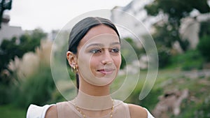 Portrait beautiful woman smiling camera at green garden. Hispanic model walking