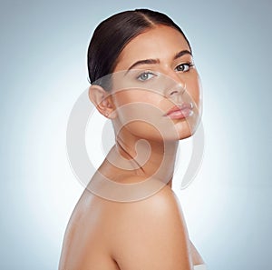 Portrait of a beautiful woman with smooth glowing skin and copyspace posing topless. Headshot of a caucasian model