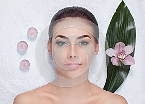 Portrait of a beautiful woman in a spa salon in front of a beauty treatment.