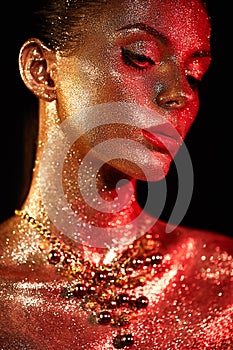 Portrait of beautiful woman with sparkles on her face