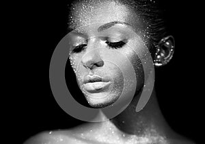 Portrait of beautiful woman with sparkles on her face