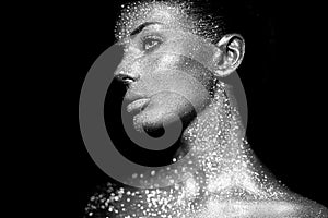 Portrait of beautiful woman with sparkles on her face