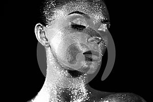 Portrait of beautiful woman with sparkles on her face