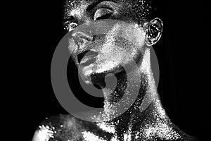 Portrait of beautiful woman with sparkles on her face