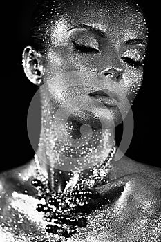 Portrait of beautiful woman with sparkles on her face