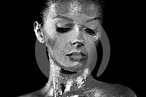 Portrait of beautiful woman with sparkles on her face