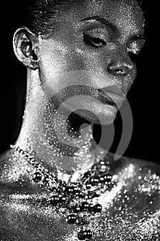 Portrait of beautiful woman with sparkles on her face