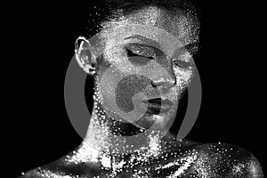 Portrait of beautiful woman with sparkles on her face