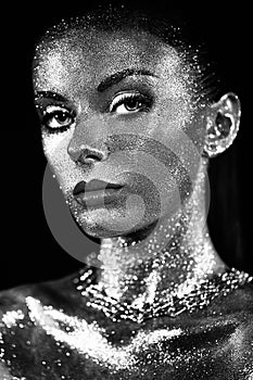 Portrait of beautiful woman with sparkles on her face