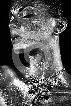 Portrait of beautiful woman with sparkles on her face