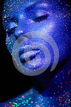 Portrait of beautiful woman with sparkles on her face