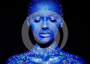 Portrait of beautiful woman with sparkles on her face