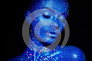 Portrait of beautiful woman with sparkles on her face