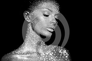 Portrait of beautiful woman with sparkles on her face