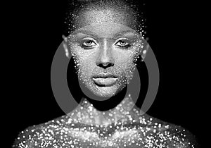 Portrait of beautiful woman with sparkles on her face