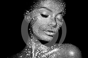 Portrait of beautiful woman with sparkles on her face