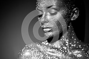 Portrait of beautiful woman with sparkles on her face