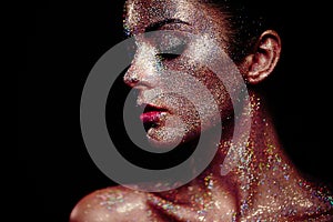 Portrait of beautiful woman with sparkles on her face