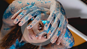 Portrait of beautiful woman with sparkles on her face. Girl with art make up