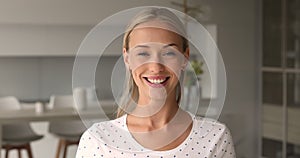 Portrait of beautiful woman standing indoors looking at camera