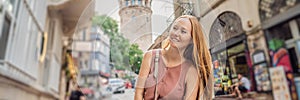 Portrait of beautiful woman tourist with view of Galata tower in Beyoglu, Istanbul, Turkey. Turkiye BANNER, LONG FORMAT