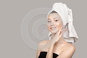 Portrait of a beautiful woman. A towel around her head. The radiance of the skin on her face.