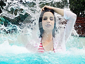 Portrait of beautiful woman under splash water