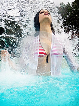 Portrait of beautiful woman under splash water