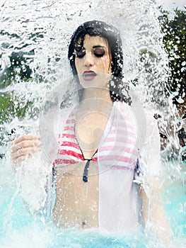 Portrait of beautiful woman under splash water