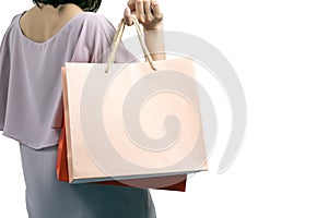 Portrait of beautiful woman wearing casual dress and holding colorful shopping bags