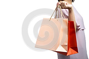 Portrait of beautiful woman wearing casual dress and holding colorful shopping bags