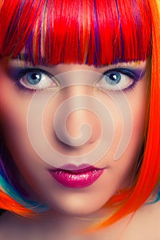 Portrait of a beautiful woman wearing colorful wig