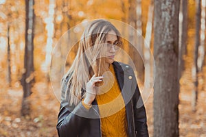 Portrait of beautiful woman wearing fashion glasses during the autumn. Stylish youth and fall season concept.