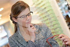 Portrait beautiful woman wearing glasses in optician store