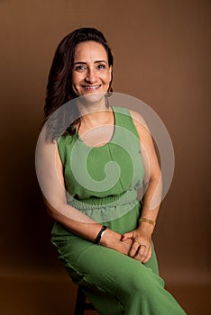 Portrait of beautiful woman, wearing green outfit. Confidence, motivation and maturity concept