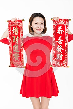 Portrait of beautiful woman wearing red dress against