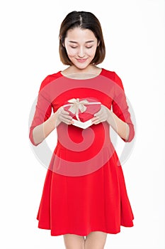 Portrait of beautiful woman wearing red dress against