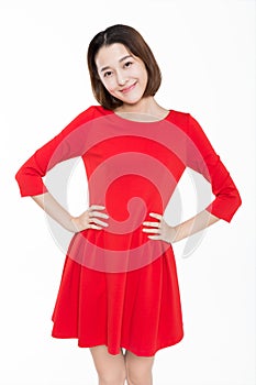 Portrait of beautiful woman wearing red dress against