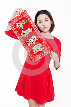 Portrait of beautiful woman wearing red dress against