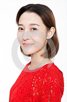 Portrait of beautiful woman wearing red dress against