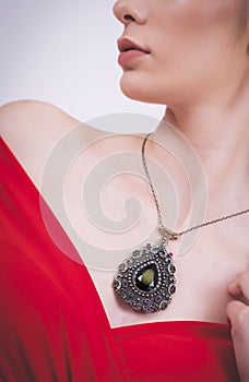 Portrait of beautiful woman wearing red dress wearing stylish necklace