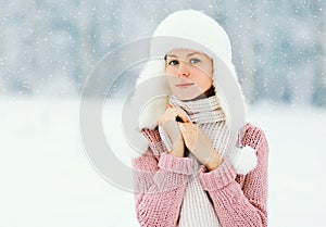 Portrait beautiful woman wearing a sweater and hat over winter