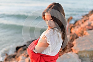 Portrait of beautiful woman in white dress at the sea beach