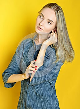 Portrait of the beautiful woman with yellow background