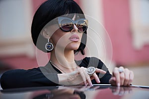 Portrait of a beautiful woman with yellow sports car