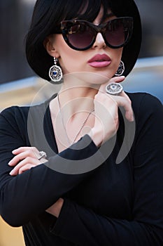 Portrait of a beautiful woman with yellow sports car