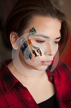 Portrait of a beautiful womans face with half human face and half face robot.