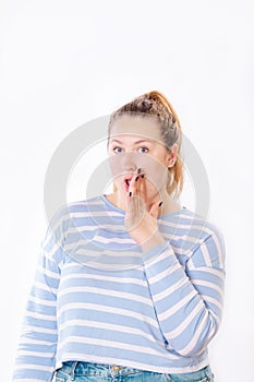 Portrait of beautiful wondered young woman with surprised face standing at isolated white background