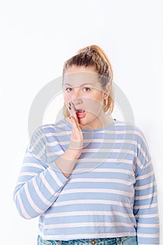 Portrait of beautiful wondered young woman with surprised face standing at isolated white background